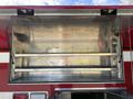 The image shows the open compartment of a 1992 Emergency One Typhoon Superior fire truck with two metal shelves inside