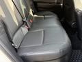 The image shows the rear seats of a 2021 Toyota C-HR featuring black leather upholstery with seat belts and a textured design on the seat cushion