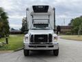 A 2019 Ford F-750 truck is positioned head-on with a white exterior and a large cargo box attached to the back