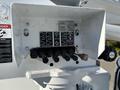Control panel of a 2005 Freightliner M2 106 featuring various switches and levers for operating a boom lift with labels for different functions