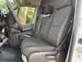 2017 Mercedes-Benz Sprinter front seats showing two black fabric seats with adjustable headrests and armrests in the cab area