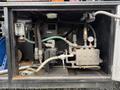 A mechanical assembly with various pipes valves and gauges installed in the compartment of a 2018 Kenworth T800 truck