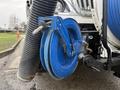 Close-up of a blue hose reel attached to a 2013 International Workstar 7500 featuring a black flexible hose Coiled and ready for use