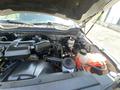 Engine compartment of a 2017 Ford F-250 SD showcasing various components including the engine block hoses and coolant reservoir