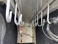 A 2015 Ford F-550 with an open bed lined with metal hooks for securing equipment or cargo
