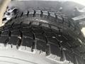Close-up view of a heavily treaded tire on a 2016 Freightliner 108SD showing deep grooves designed for traction and stability