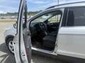 A 2014 Ford Escape with the front driver's door open showing the interior including the steering wheel and front seats