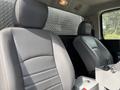 Interior of a 2016 RAM 5500 featuring two grey leather seats with a simple design and a console in between them