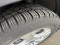 Close-up of a 2014 Ford Escape tire showcasing a detailed tread pattern with visible wear and a silver alloy wheel