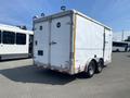 A 2008 Wells Industries Inc EW1422 trailer with a white exterior and a double axle positioned at the rear