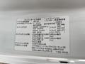 A 2010 Suzuki Carry with an engine specification label detailing information such as engine type, oil filter, and maintenance intervals