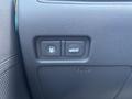 Two buttons on the dashboard of a 2014 Hyundai Sonata for fuel and trunk release