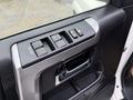 Close-up of the interior door panel of a 2018 Toyota 4Runner featuring window controls and a door handle
