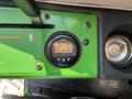 Dashboard of a 2021 John Deere 1575 featuring a digital display with numbers and buttons for operational settings