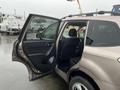 A 2016 Subaru Forester with the driver's side door open revealing the interior and seating area