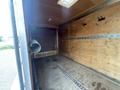 Interior view of a 2016 Continental cargo trailer featuring wooden walls and floor with metal tracks and hooks for securing cargo