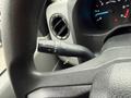 Close-up view of the control lever for windshield wipers and turn signals on the steering column of a 2024 Ford E-450