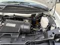 The engine compartment of a 2015 GMC Savana showing the air intake system and various engine components including a fluid reservoir and electrical connections