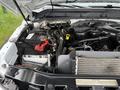 The engine compartment of a 2016 Ford F-550 Super Duty showing the battery air intake and various engine components including hoses and a radiator