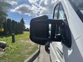 A white 2023 RAM Promaster 3500 van with a prominent side mirror is displayed in the foreground