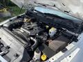 A 2013 RAM 5500 engine bay showcasing the engine components including the air intake and battery with various fluids and connections visible