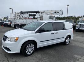 A 2014 RAM Cargo Van in white parked with a sleek design and alloy wheels