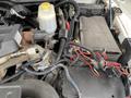 Engine compartment of a 2011 Dodge Ram 5500 with visible components including wiring harnesses battery and fluid reservoir