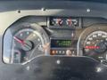 The dashboard of a 2012 Ford Econoline showing speedometer fuel gauge and trip odometer readings
