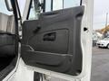 The image shows the interior door of a 2013 International Workstar 7500 with a black panel and a handle for opening and closing the door