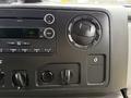 Dashboard controls of a 2017 Ford E450 including a radio display knobs and auxiliary input port