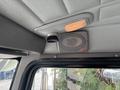 Interior view of a 2008 Peterbilt 340 featuring a ceiling mounted speaker and light in a gray textured finish