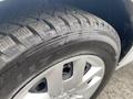 A close-up of a tire on a 2014 RAM Cargo Van showing tread patterns and rim details
