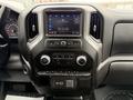 Dashboard of a 2022 GMC Sierra 1500 featuring a touchscreen display with audio controls and climate settings along with physical buttons and knobs