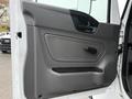 Interior door panel of a 2020 International MV607 featuring a textured gray surface with a door handle and a control knob for window operation