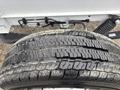 A close-up of a worn tire from a 2023 RAM Promaster 3500 showing visible tread wear and surface cracks