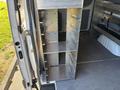 A metal shelving unit with multiple shelves installed inside a 2024 Mercedes-Benz Sprinter 2500 van