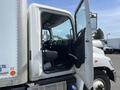 A 2018 Hino 338 truck with the driver's door open showing the interior including the driver's seat and dashboard