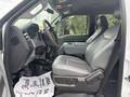 A 2014 Ford F-550 with gray leather upholstery in the front seat area showcasing the driver's side and console