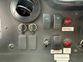 Control panel of a 2012 Ford Econoline featuring switches for lights fans seatbelt indicators and door alerts