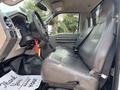Interior view of a 2009 Ford F-450 Super Duty showing the driver's seat and dashboard with a key hanging from the ignition