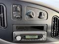 Dashboard controls of a 2002 Ford Econoline showing climate control knobs and a car stereo display