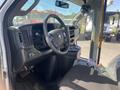 Interior of a 2020 Chevrolet Express showing the driver's seat steering wheel dashboard and control buttons