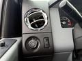 Close-up of the dashboard controls in a 2012 Ford F-550 featuring an air vent and various knobs for lights and other functions
