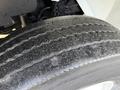 Close-up of a worn tire from a 2013 International Durastar 4300 showing visible tread wear and surface dirt