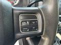 Close-up of the steering wheel controls of a 2013 RAM 2500 featuring buttons for on off cancel resume and set