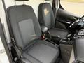 Interior of a 2019 Ford Transit Connect showing two fabric-covered front seats and a central console with gear shift and storage compartments