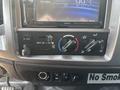 Dashboard controls of a 2012 Hino 338 featuring air conditioning and heating knobs alongside a radio display