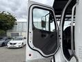 A 2021 Freightliner M2 106 truck door is open showing the interior and controls designed for commercial use