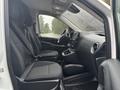 Interior of a 2021 Mercedes-Benz Metris showing two front seats with seatbelts and a dashboard with steering wheel and controls