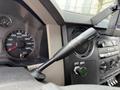Close-up of the gearshift lever and dashboard of a 2008 Ford F-550 showing the speedometer and control knobs